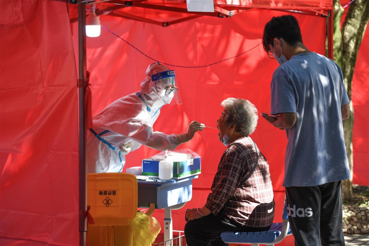 <i>Yang Wenbin/Xinhua/Getty Images</i><br/>A medical worker takes a swab sample from a resident for nucleic acid test at a community testing site for Covid-19 in Yunyan District of Guiyang