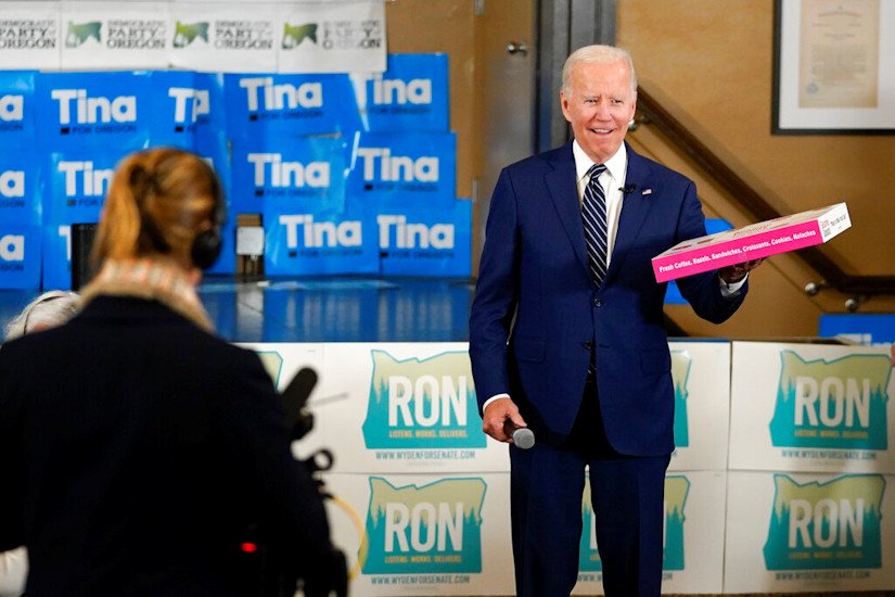 President Joe Biden holds a box of doughnuts during a grassroots volunteer event with the Oregon Democrats at the SEIU Local 49 in Portland on Friday evening