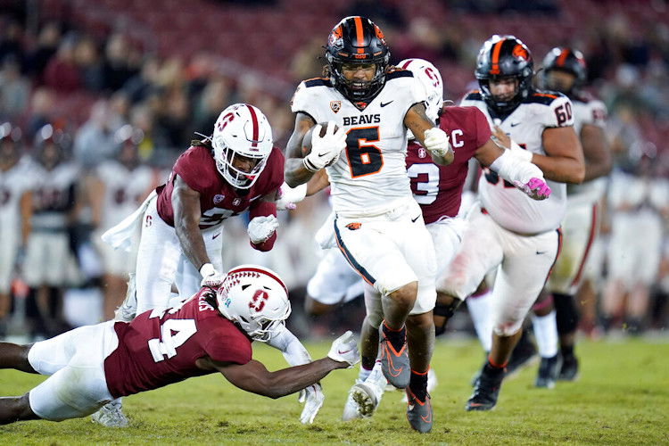 Oregon State running back Damien Martinez (6) runs the ball for a 43-yard touchdown as Stanford safety Patrick Fields (24) tries to tackle him during the second half of Saturday night's contest