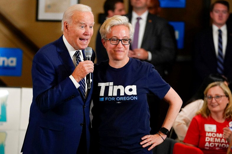 President Joe Biden stands with Tina Kotek, the Oregon Democratic nominee for governor, as he speaks during a grassroots volunteer event with the Oregon Democrats at the SEIU Local 49 in Portland on Friday