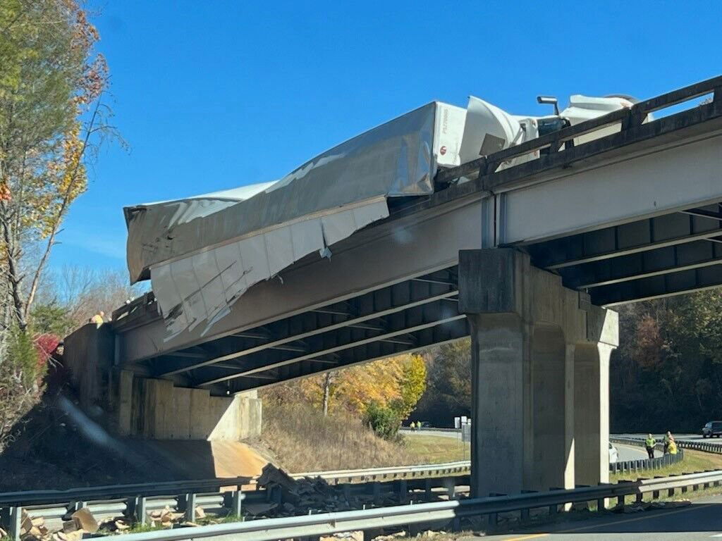 <i>WLOS</i><br/>Jackson County Emergency Management says crews responded to a crash involving a tractor trailer on the on ramp at exit 85 of US 74. Westbound lanes were closed off due to the crash. Part of the truck's trailer could be seen hanging off of the overpass.