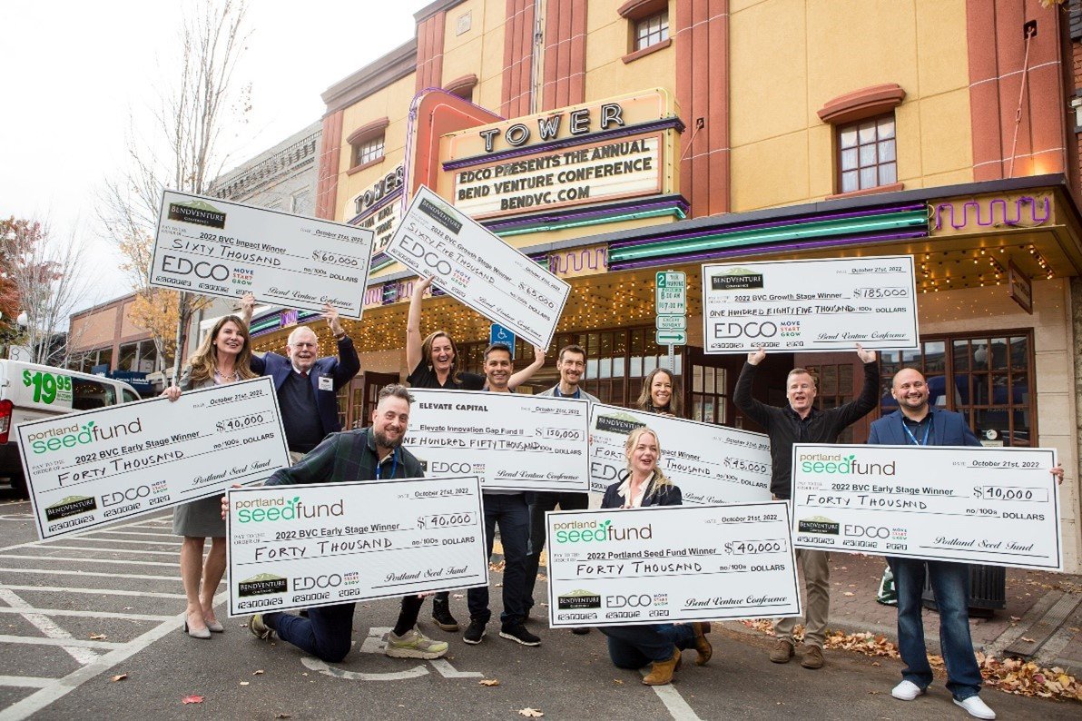 Seven Bend Venture Conference funding recipients display their oversized checks