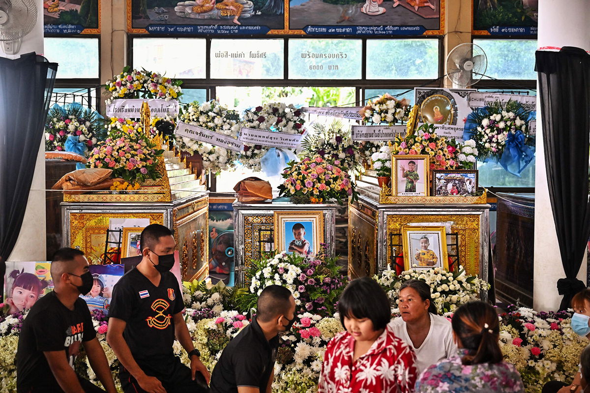 <i>Lillian Suwanrumpha/AFP/Getty Images</i><br/>Relatives gather in front of the coffins of victims of the daycare mass shooting at Wat Rat Samakee temple in northeastern Nong Bua Lam Phu province on October 9.