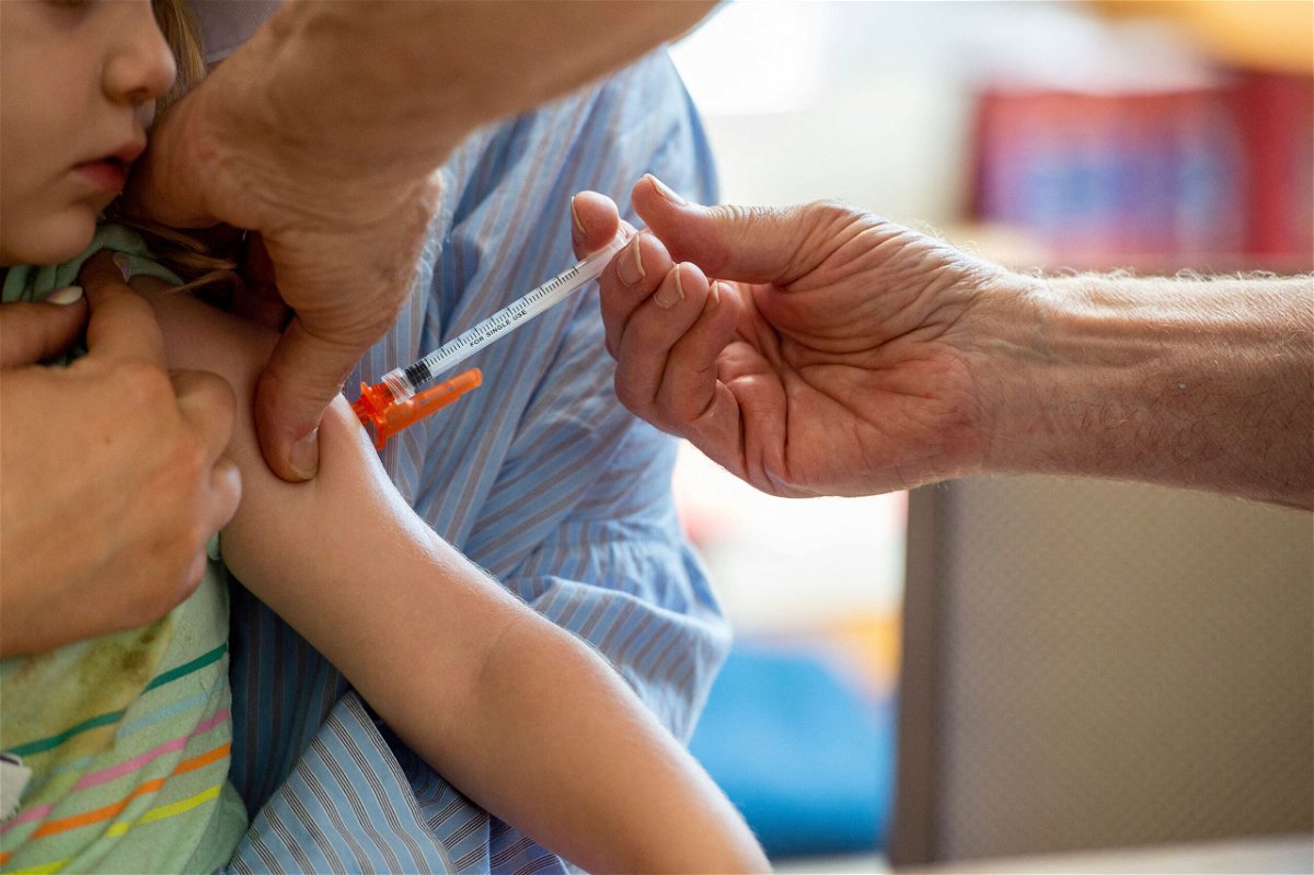 <i>Joseph Prezioso/AFP/Getty Images</i><br/>A young child receives a Moderna Covid-19 6 months to 5 years vaccination at Temple Beth Shalom in Needham