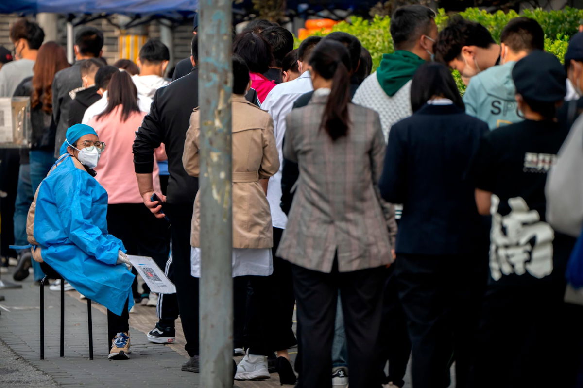 <i>Mark Schiefelbein/AP</i><br/>People line up for Covid tests in Beijing