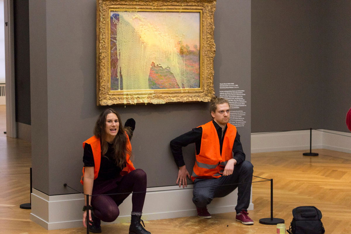 <i>Last Generation/AP</i><br/>Climate protesters from the group Last Generation after throwing mashed potatoes at Monet's 
