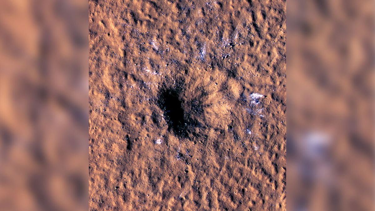 <i>NASA/JPL-Caltech/University of Arizona</i><br/>Boulder-size ice chunks can be seen scattered around and outside the new crater's rim.