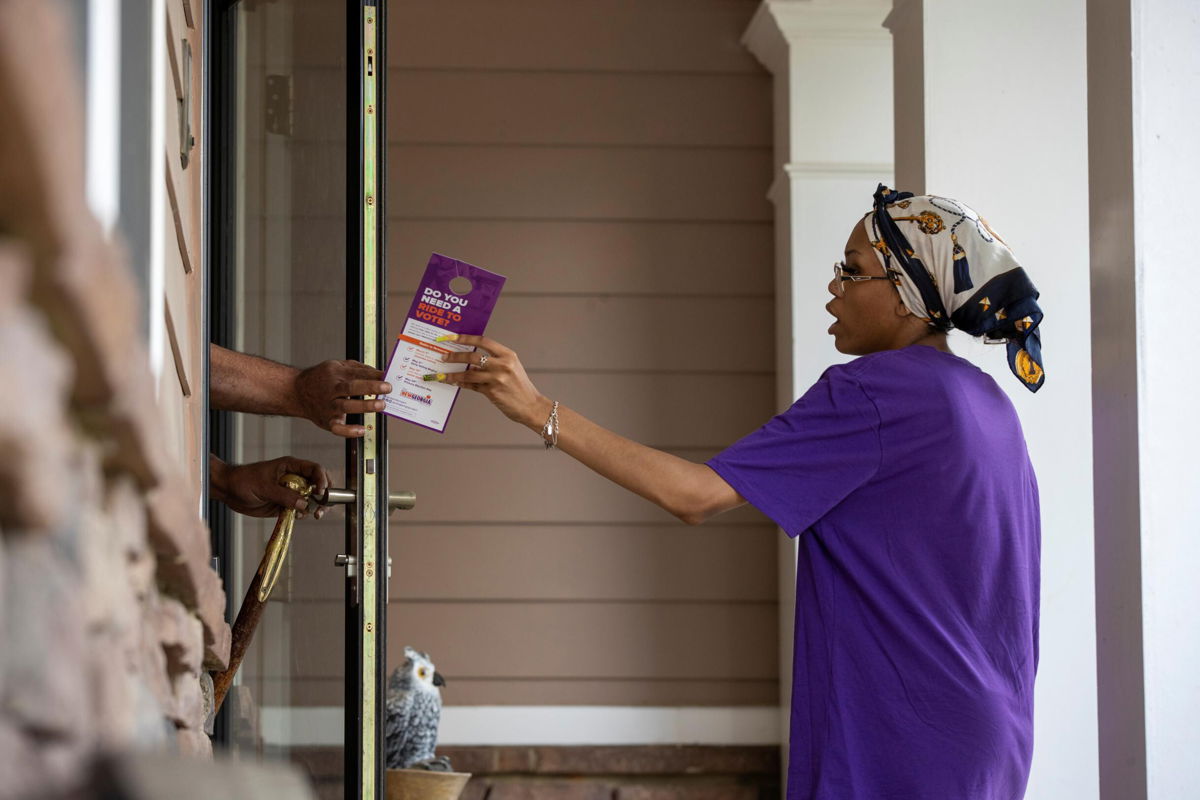 <i>Alyssa Pointer/Reuters</i><br/>A canvasser for the New Georgia Project hands an informative flyer to a resident in Fairburn