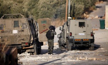 Palestinian youths and Israeli forces clash as troops surround a building in the village of Deir al-Hatab. A Palestinian man was killed and two journalists shot and injured by Israeli forces during an Israeli military raid on October 5.