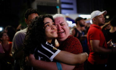 Supporters of Lula da Silva react as they wait for results in Sao Paulo