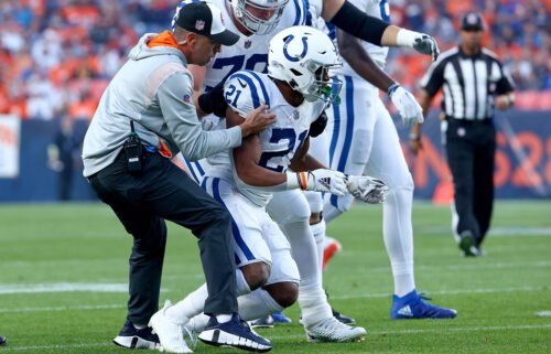 Indianapolis Colts running back Nyheim Hines is helped to his feet after being hit during a game against the Denver Broncos at Empower Field At Mile High on October 6 in Denver