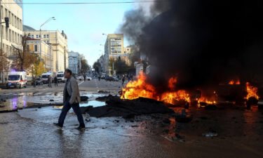 Cars burn after a Russian military strike in Kyiv