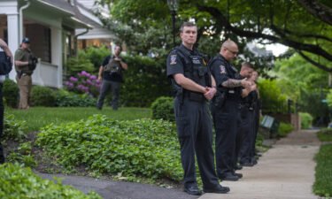 Police officers stand outside the home of U.S. Supreme Court Justice Brett Kavanaugh in anticipation of an abortion-rights demonstration on May 18