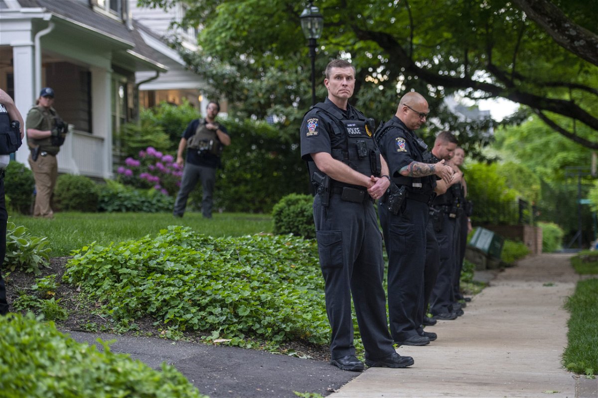 <i>Bonnie Cash/Getty Images</i><br/>Police officers stand outside the home of U.S. Supreme Court Justice Brett Kavanaugh in anticipation of an abortion-rights demonstration on May 18
