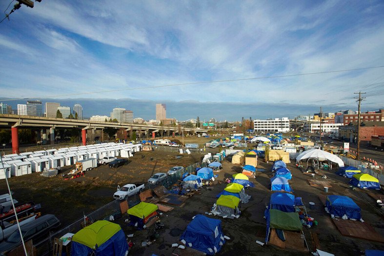 Homeless camps are seen in a vacant parking lot in Portland, Ore., Tuesday, Dec. 8, 2020