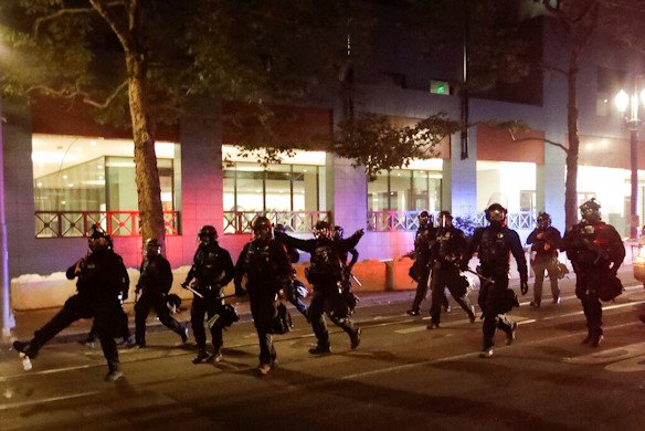 Portland police chase demonstrators during a Black Lives Matter protest on July 26, 2020, in Portland