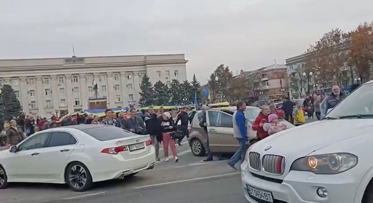 <i>Reuters</i><br/>Crowd cheer and chant as they surround a car with Ukrainian soldiers in Kherson's main square on November 11. Ukrainian forces swept into the key city of Kherson on Friday as Russian troops retreated to the east.