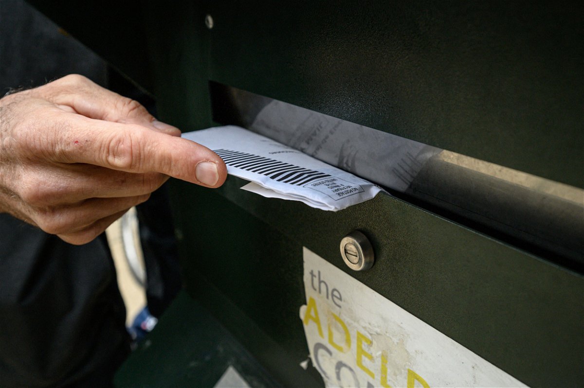 <i>Ed Jones/AFP/Getty Images</i><br/>A voter casts their ballot at a drop box outside the Philadelphia city hall on October 24. The Pennsylvania Supreme Court has ordered that any general election ballots that are mailed in undated or incorrectly dated envelopes must be set aside and not counted.