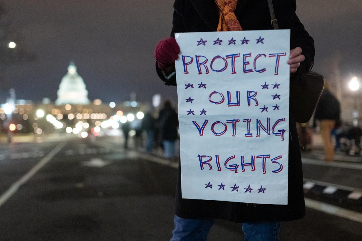 <i>Eric Lee/Bloomberg /Getty Images</i><br/>The Justice Department has taken several bold steps on voting issues. A protester here holds a sign in Washington