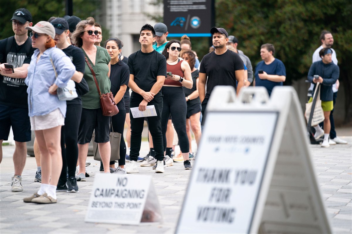 <i>Sean Rayford/Getty Images</i><br/>People wait in line on the final day of early voting at a polling location at Bank of America Stadium on November 5 in Charlotte