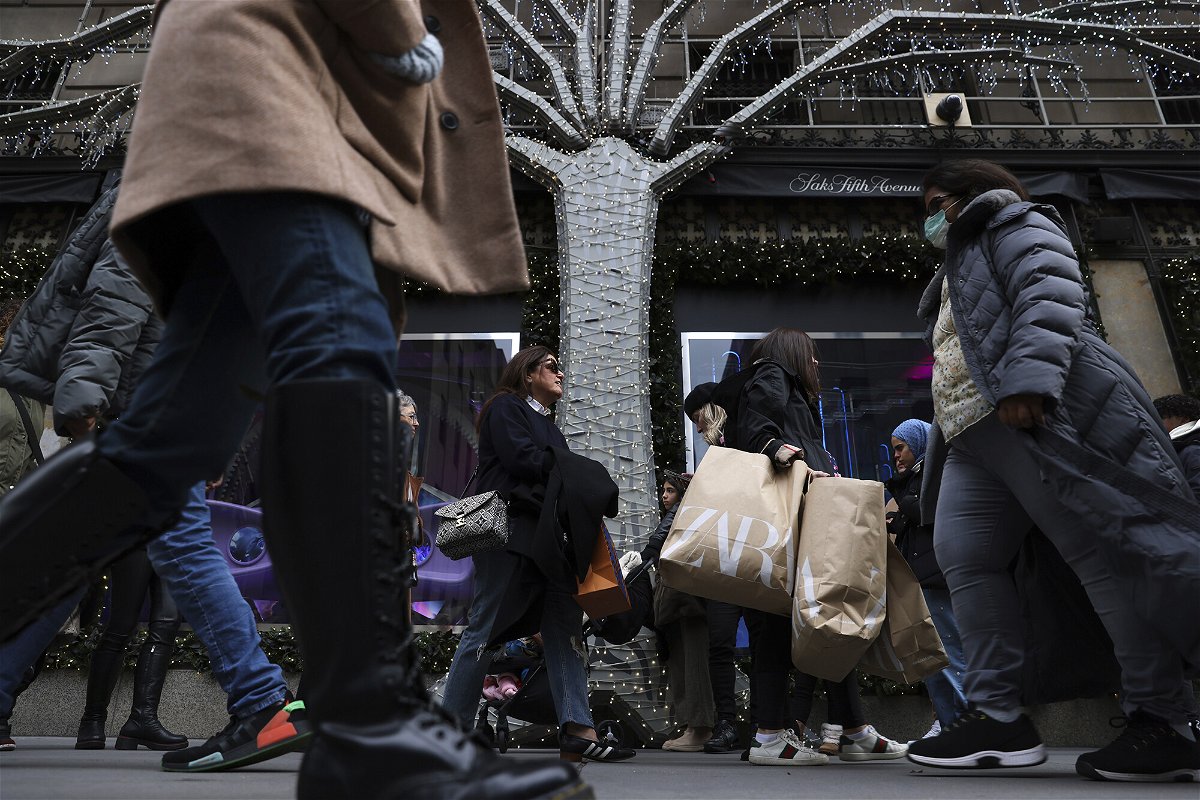 <i>Julia Nikhinson/AP</i><br/>Consumers are keeping the economy afloat. Shoppers carry bags down Fifth Avenue on Black Friday