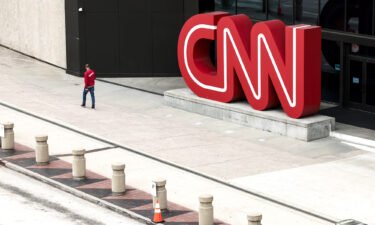 CNN begins layoffs in what CEO says will be a 'gut punch' to the network. People walk by the CNN headquarters on March 15