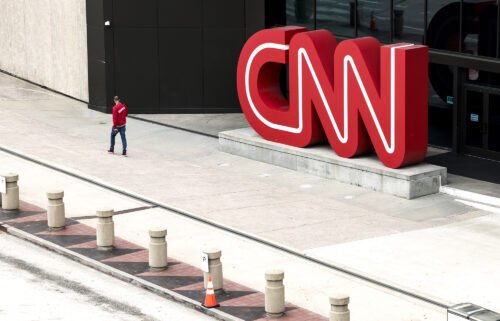 CNN begins layoffs in what CEO says will be a 'gut punch' to the network. People walk by the CNN headquarters on March 15