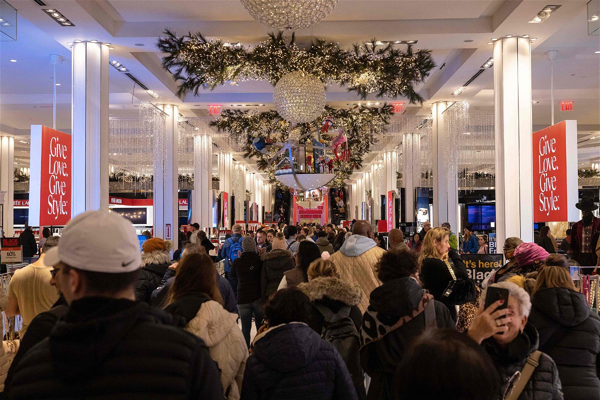 <i>Yuki Iwamura/AFP/Getty Images</i><br/>People shop at Macy's department store during Black Friday in New York City on November 25. American consumers got holiday shopping off to a strong start.