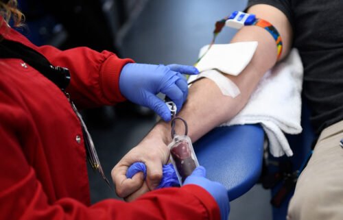 A person donates blood during a Children's Hospital Los Angeles blood donation drive on January 13. The US Food and Drug Administration is considering shifting its blood donation policy away from blanket assessments toward questionnaires that focus more on individual risk.