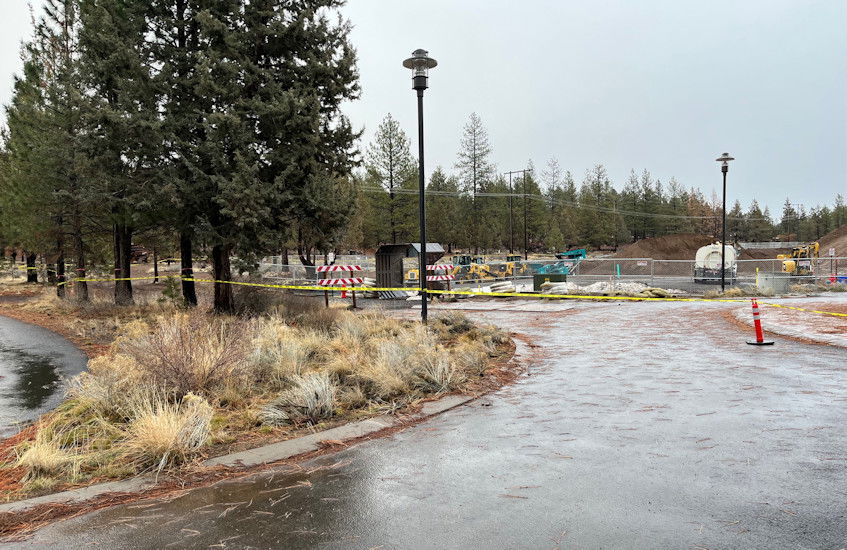 Caution tape surrounds apartment project by COCC's Bend campus on Tuesday