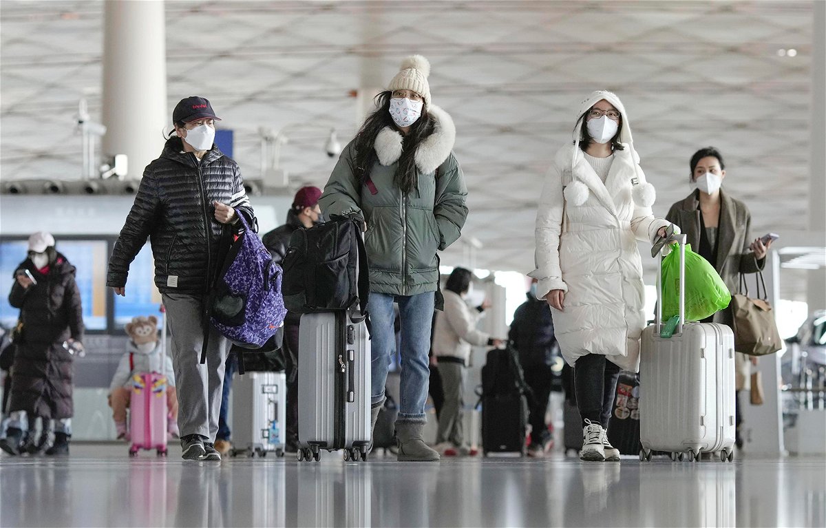 <i>Kydpl Kyodo/AP</i><br/>Passengers at the departure hall in Beijing's international airport on December 27.
