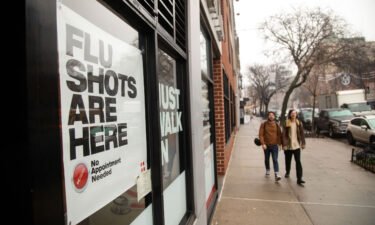 People walk past an urgent care facility offering flu shots in New York on Dec. 7