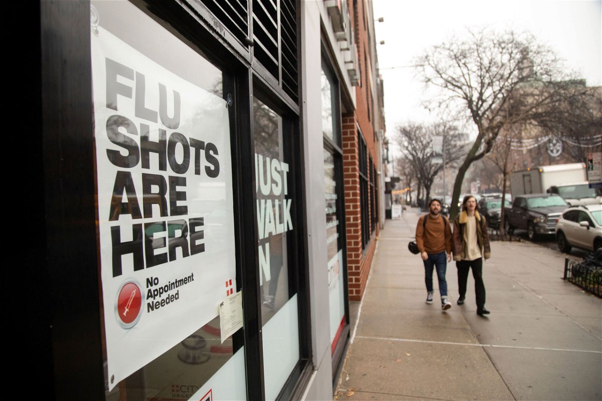 <i>Michael Nagel/Xinhua News Agency/Getty Images</i><br/>People walk past an urgent care facility offering flu shots in New York on Dec. 7