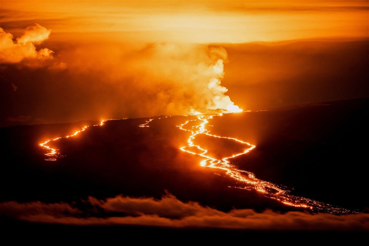 <i>Go Nakamura/Reuters</i><br/>Lava fountains and flows illuminate the area during the Mauna Loa volcano eruption in Hawaii