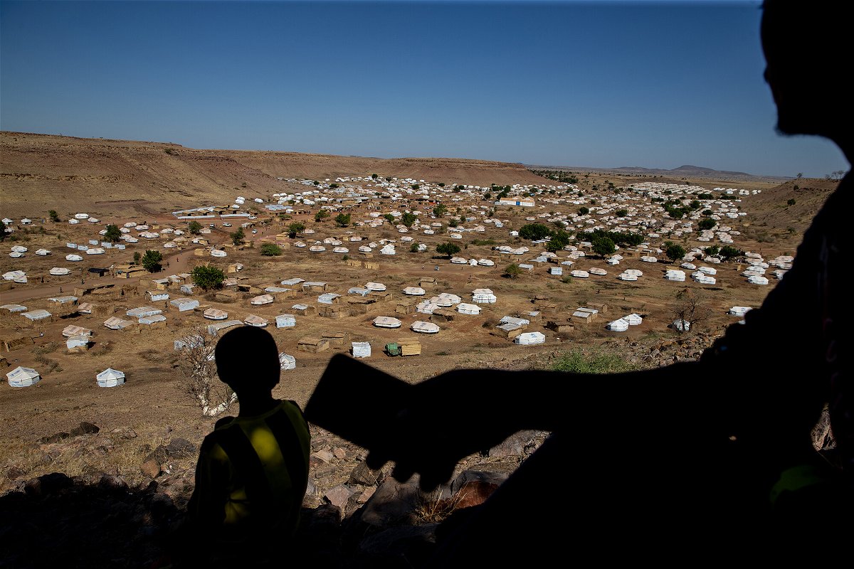 <i>Abdulmonam Eassa/Getty Images</i><br/>A Tigrayan man looks for cellular phone service on a mountain overlooking Um Rakuba refugee camp in eastern Sudan in January.