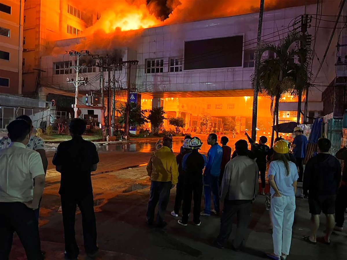 <i>Courtesy Peerapan Srisakorn</i><br/>Firefighters work at the Grand Diamond City Hotel and Casino in Poipet