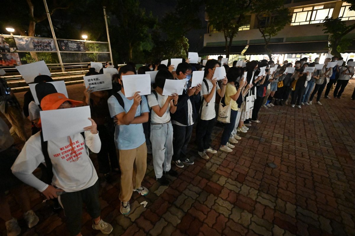 <i>Peter Parks/AFP/Getty Images</i><br/>Students hold up placards