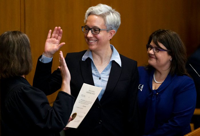 Tina Kotek was accompanied by her wife Aimee Wilson, right, as Kotek was sworn in as Oregon governor at the state Capitol building in Salem, on Monday
