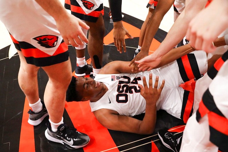 Oregon State center KC Ibekwe (24) is helped up from the floor during a celebration of the team's 60-52 win over Colorado