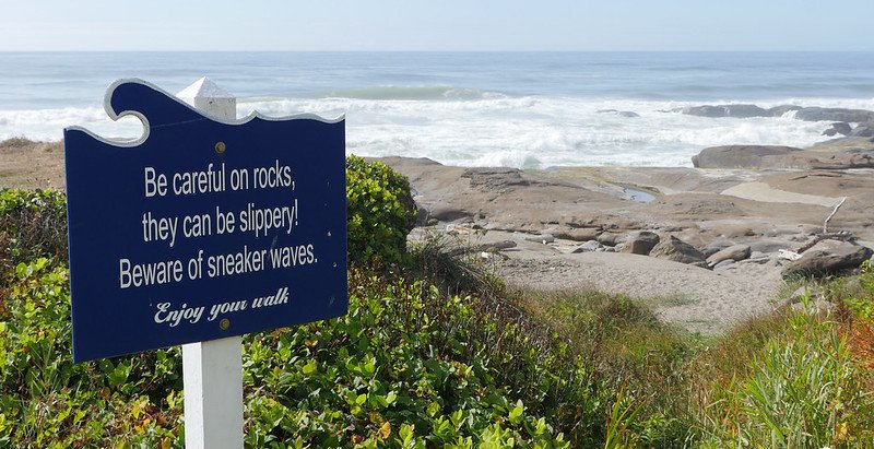 A sign warns visitors about sneaker waves in Yachats, Oregon.