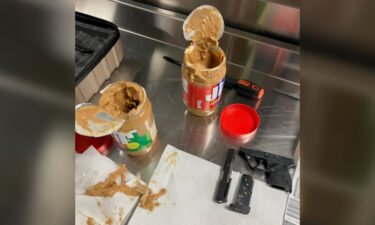 Parts of a disassembled .22 semiautomatic handgun were found hidden in two jars of peanut butter in a traveler's checked luggage.