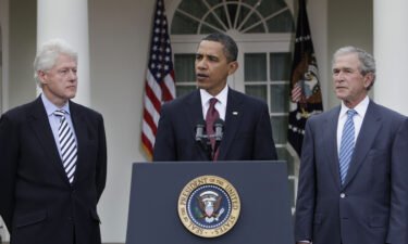 President Barack Obama (center) speaks as former Presidents Bill Clinton (left) and George W. Bush (right) listen in the Rose Garden at the White House in January of 2010.