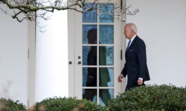 President Joe Biden walks to the Oval Office on January 23