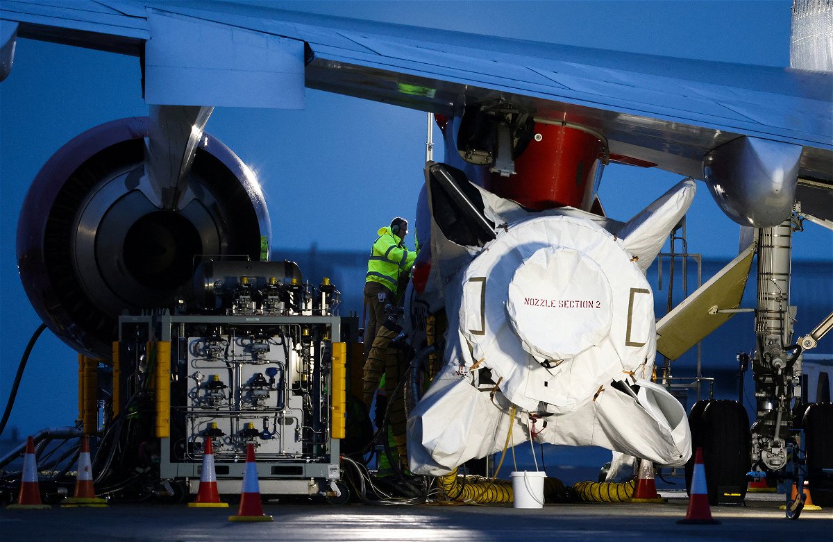 <i>Henry Nicholls/Reuters</i><br/>Technicians work on Virgin Orbit's LauncherOne rocket