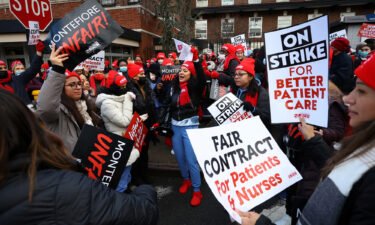Union nurses chant slogans on the picket line outside Montefiore Hospital in the Bronx borough of New York City