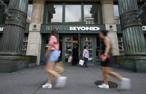 People walk past the entrance to a Bed Bath & Beyond retail store along Sixth Avenue in New York in September of 2022.