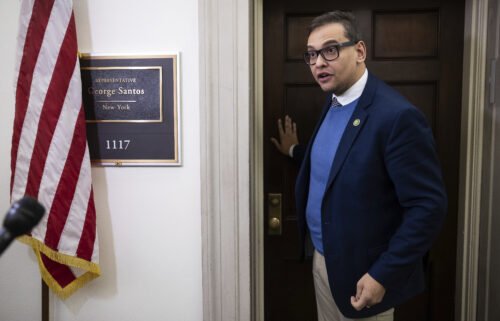 Rep. George Santos speaks with journalists outside his office on Capitol Hill on January 26.