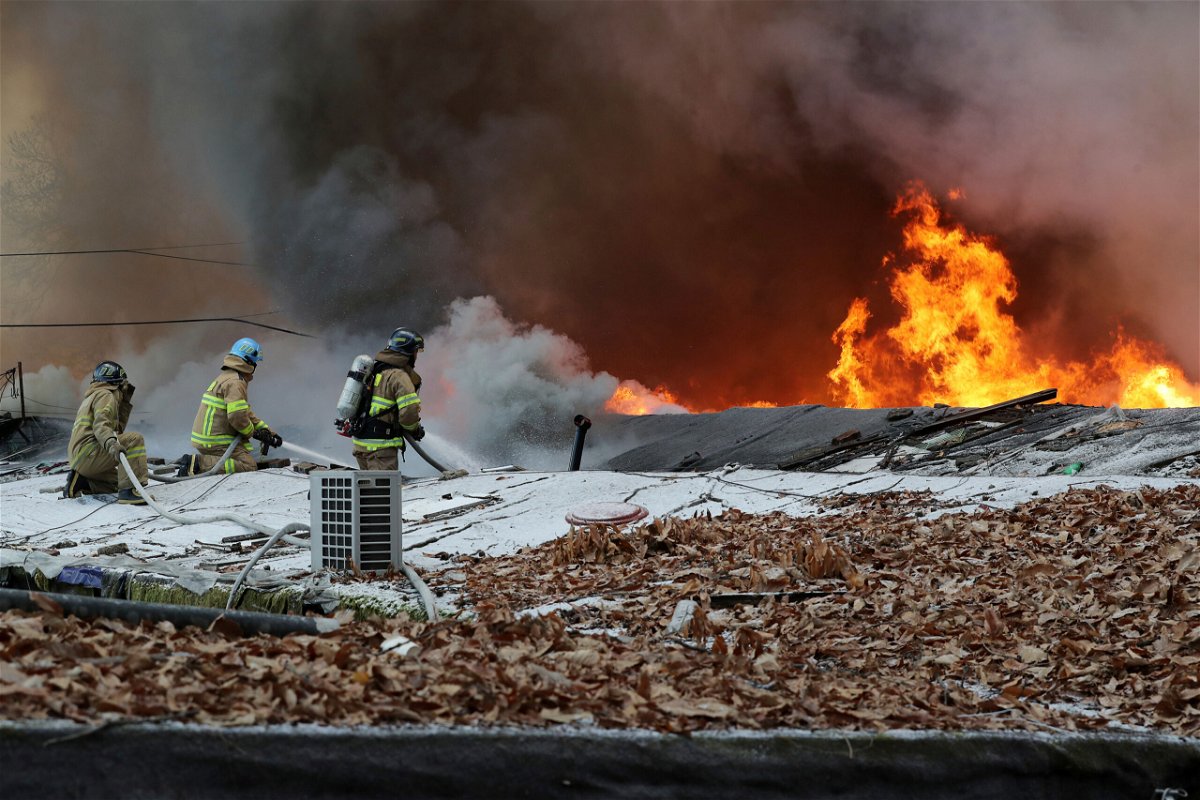 <i>Baek Dong-hyun/Newsis/AP</i><br/>Firefighters battle a fire at Guryong village in Seoul