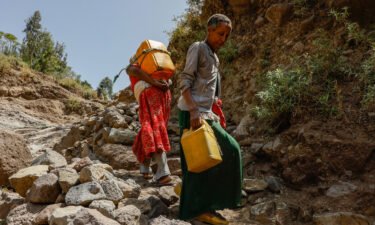 A woman in Ethiopia is pictured here carrying water after the armed conflict in the Tigray region knocked out infrastructure.