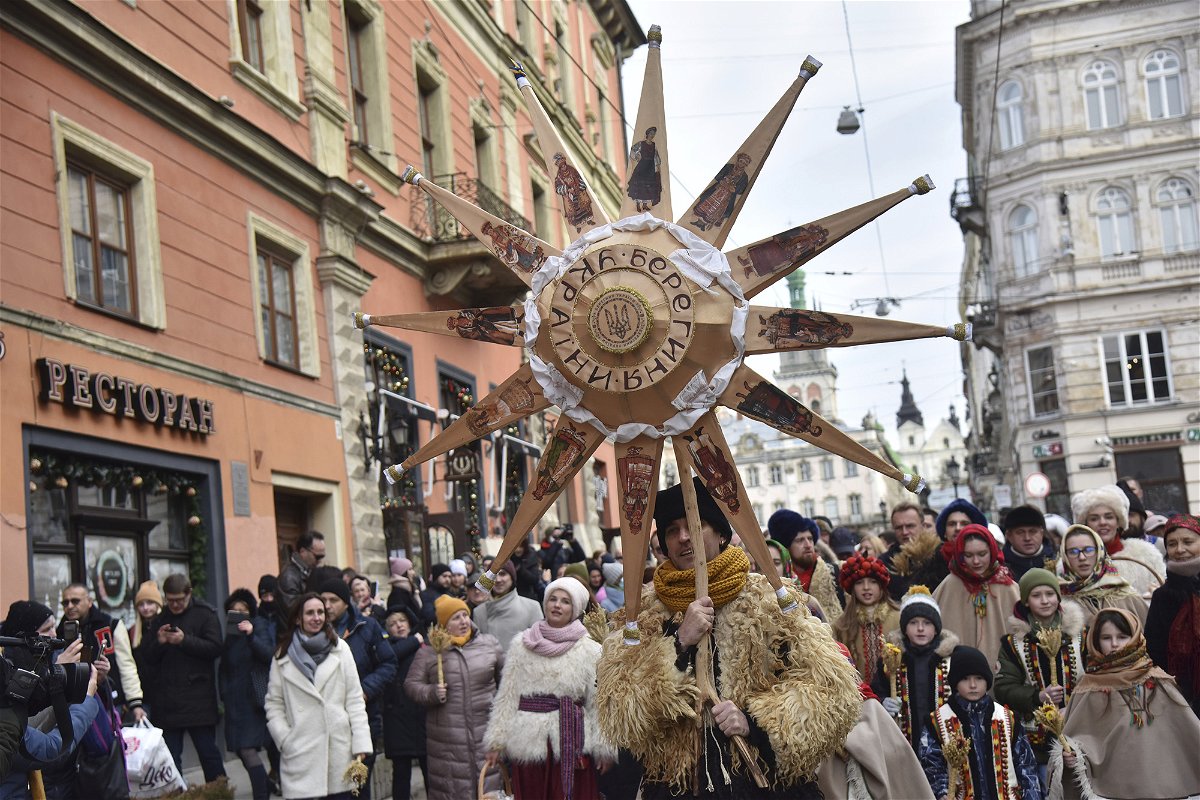 <i>Pavlo Palamarchuk/SOPA Images/SIPAPRE/Sipa USA/AP</i><br/>Ukrainians sing Christmas carols as they carry decorated stars of Bethlehem and sheaves of wheat in their hands during a festive parade in Lviv on January 6